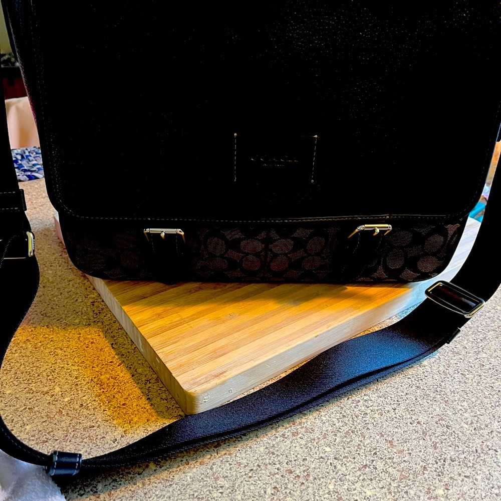 Black leather Coach messenger bag. Logo  canvas on bottom